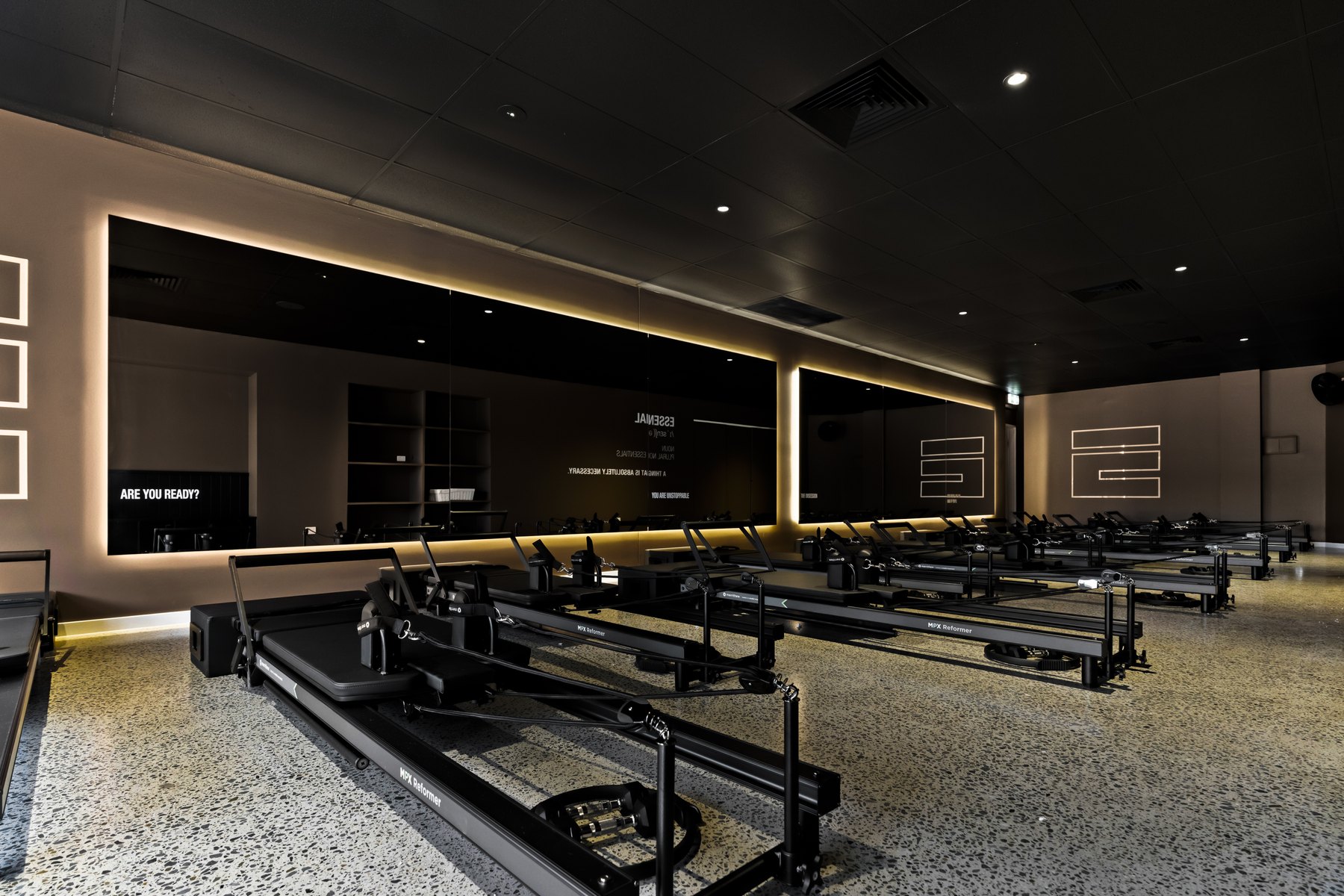Essential Pilates Chirn Park studio with reformer beds and feature lighting